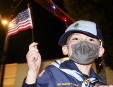 Cub Scouts and Girl Scouts waved flags during the annual parade.